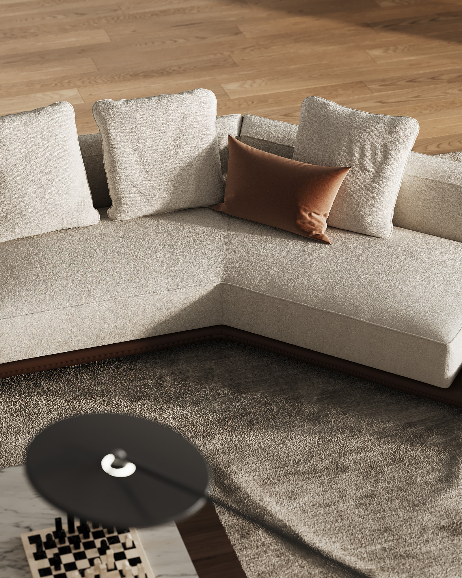 Bird's-eye view of a light-colored corner sofa next to a round table