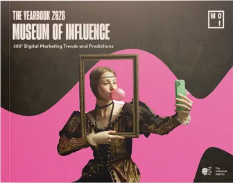 Cover of The Yearbook 2026 Museum of Influence featuring a woman in historical dress blowing bubblegum and holding a smartphone to take a selfie inside a picture frame.