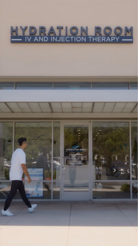 Entrance of Hydration Room IV and Injection Therapy clinic with a person walking by.