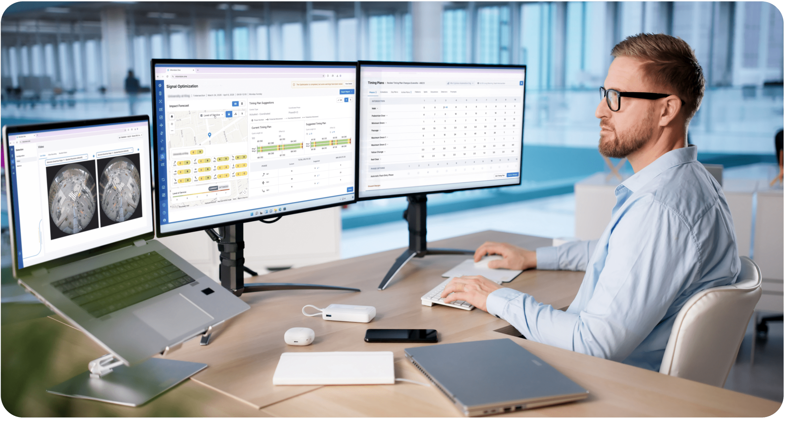 Traffic professional reviewing intersection and signal timing data on multiple monitors using Miovision's software.