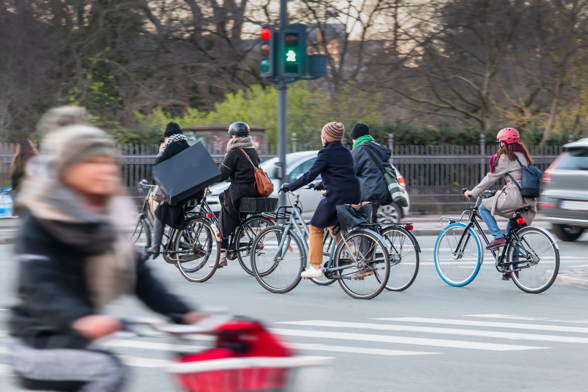 Cyclists and pedestrians crossing at a signalized city intersection, representing the vulnerable road users Miovision's safety studies help protect.