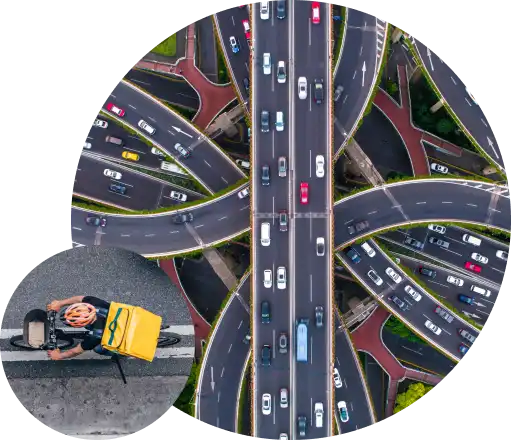 Aerial view of a major highway interchange with heavy traffic, representative of the intersections Miovision's traffic technology manages.