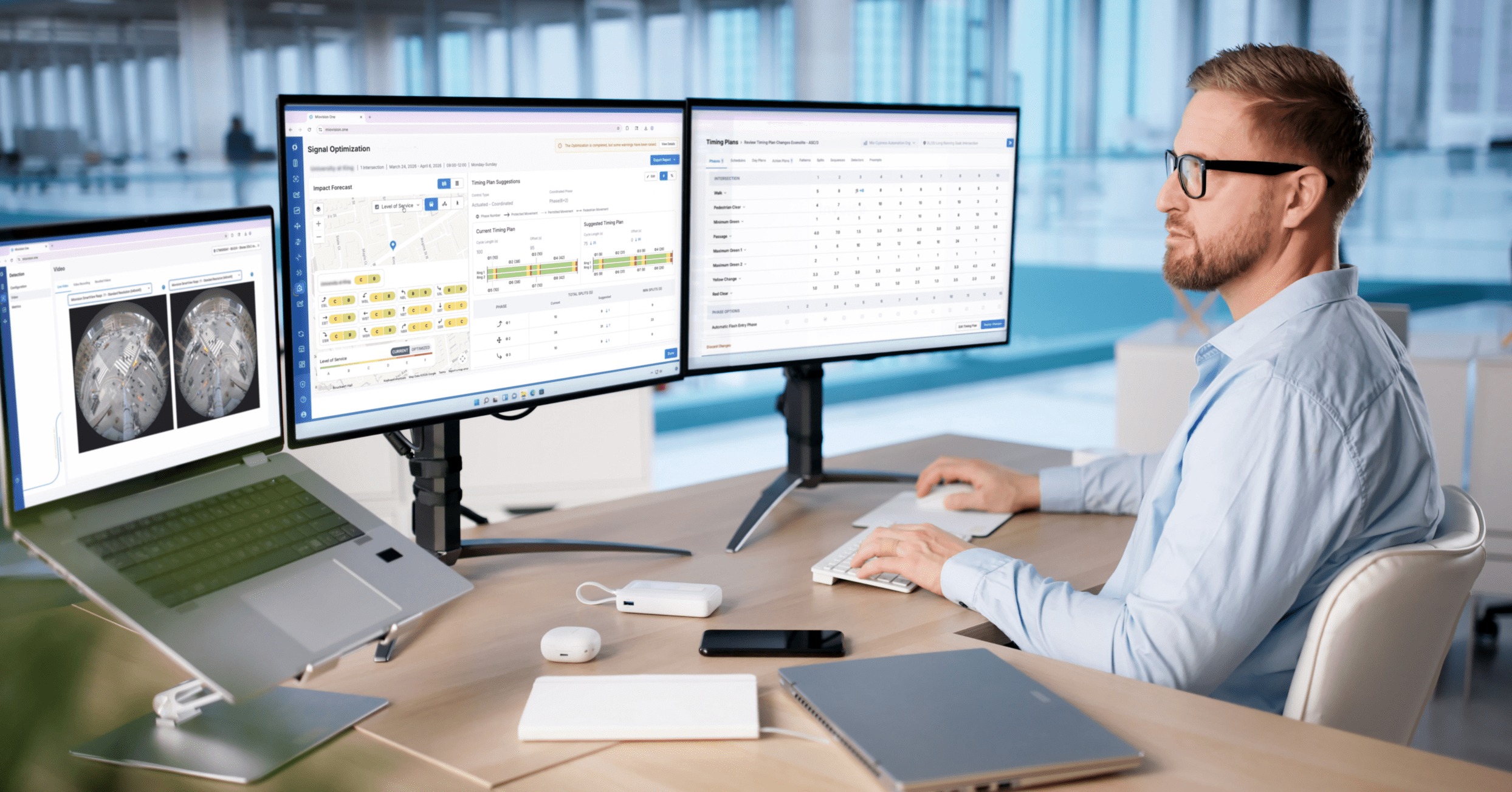 Traffic professional reviewing intersection and signal timing data on multiple monitors using Miovision's software.