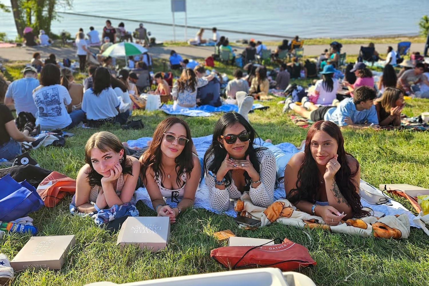 Friends lying on the grass together at a Water Lantern Festival event