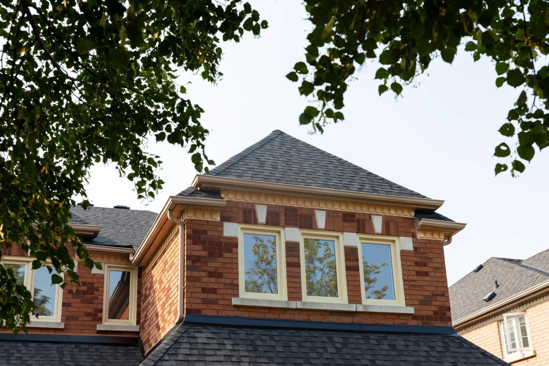 Three new Clera windows on a brick home dormer
