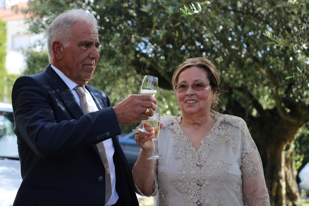 a man and a woman holding wine glasses