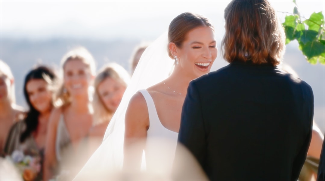 a bride and groom smiling at each other