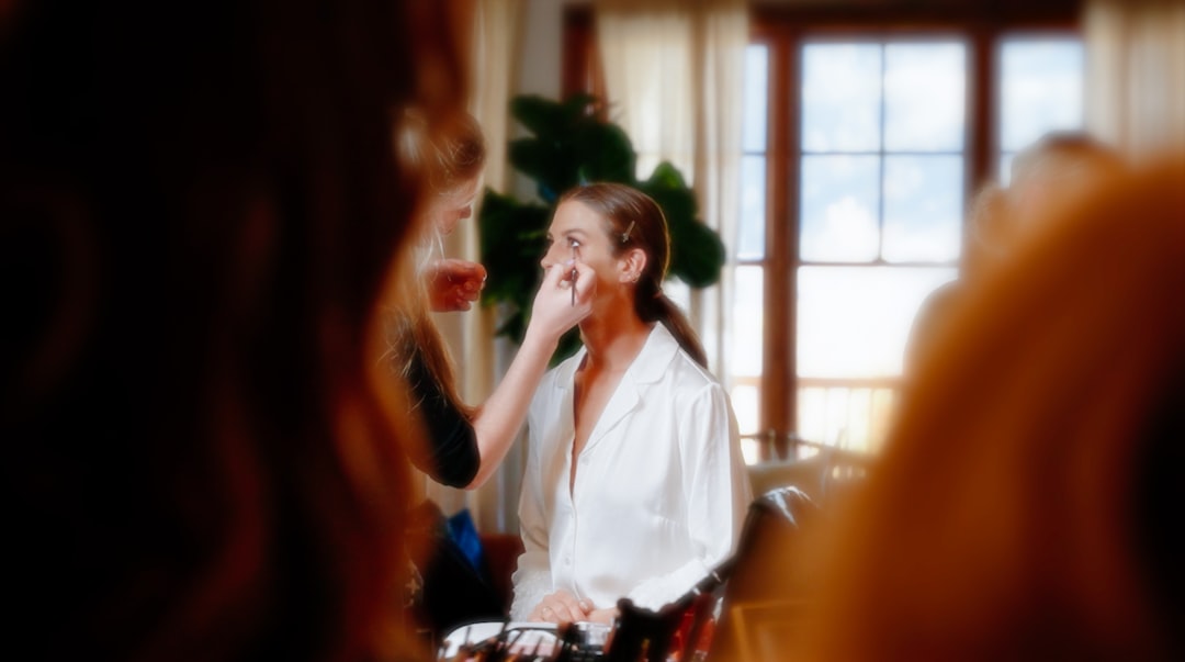 a woman brushing her teeth in front of a mirror