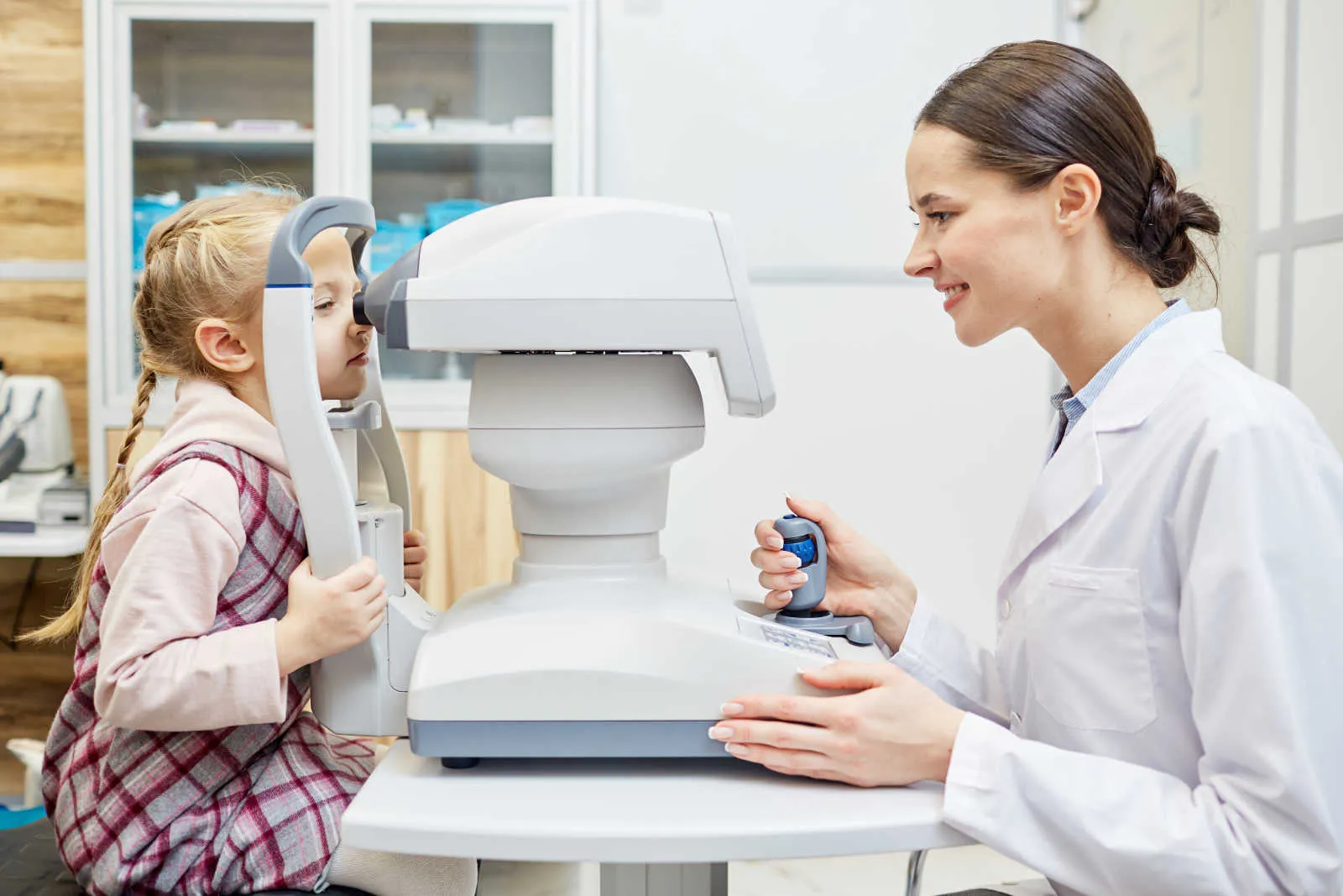 Little girl getting her eyes tested by an eye doctor