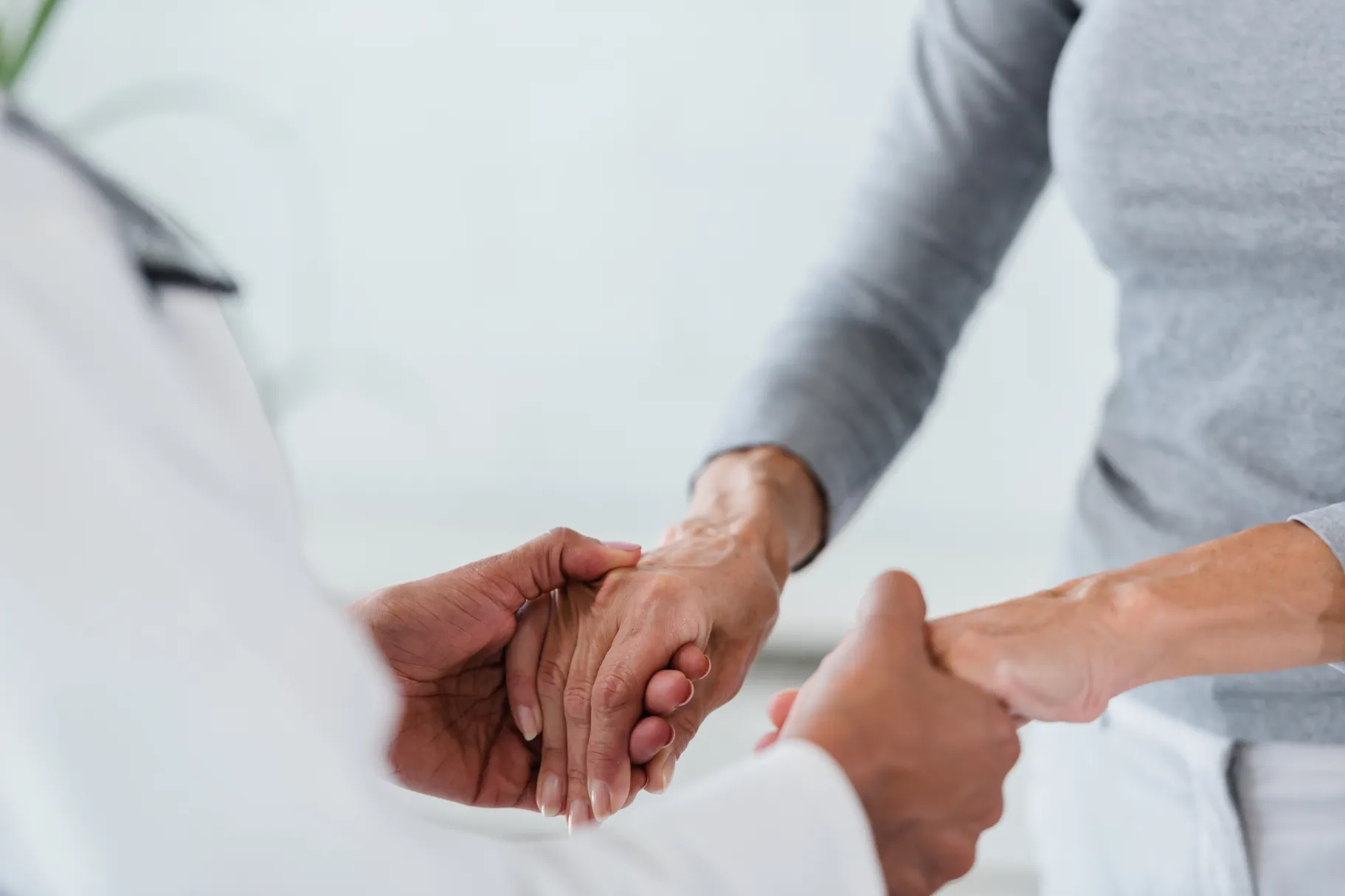 Doctor holding hands with a patient