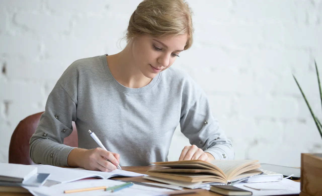 woman smiling and working at desk 