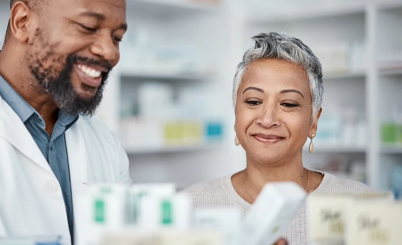 Woman with male pharmacist in pharmacy 