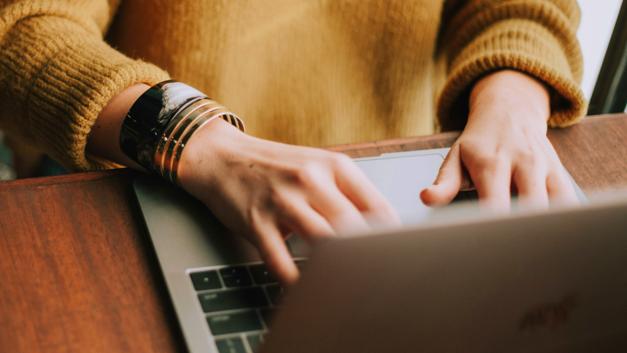 Close up of a person typing on a laptop