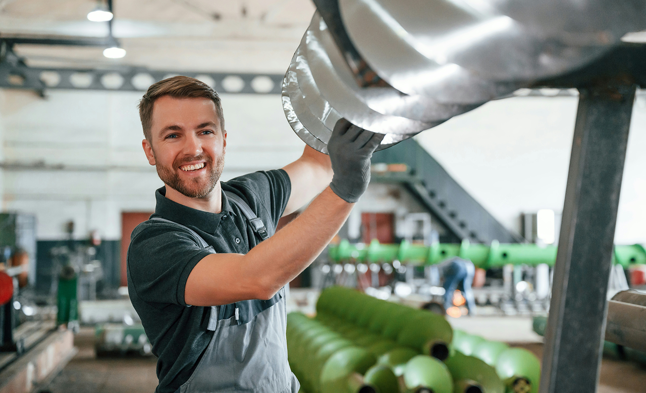 Man working in a factory manufacturing an object