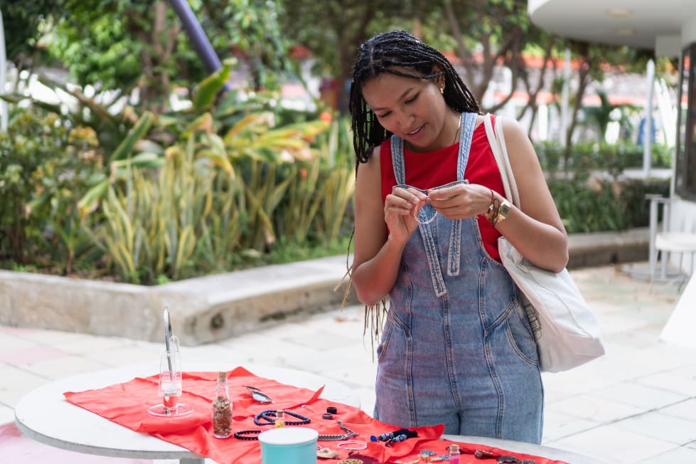 Artisan making jewelry at an outdoor market