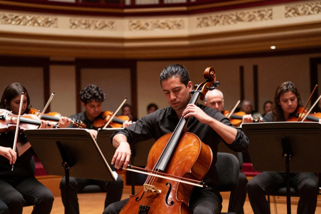 Cellist performing with an orchestra during a Festival Casals concert