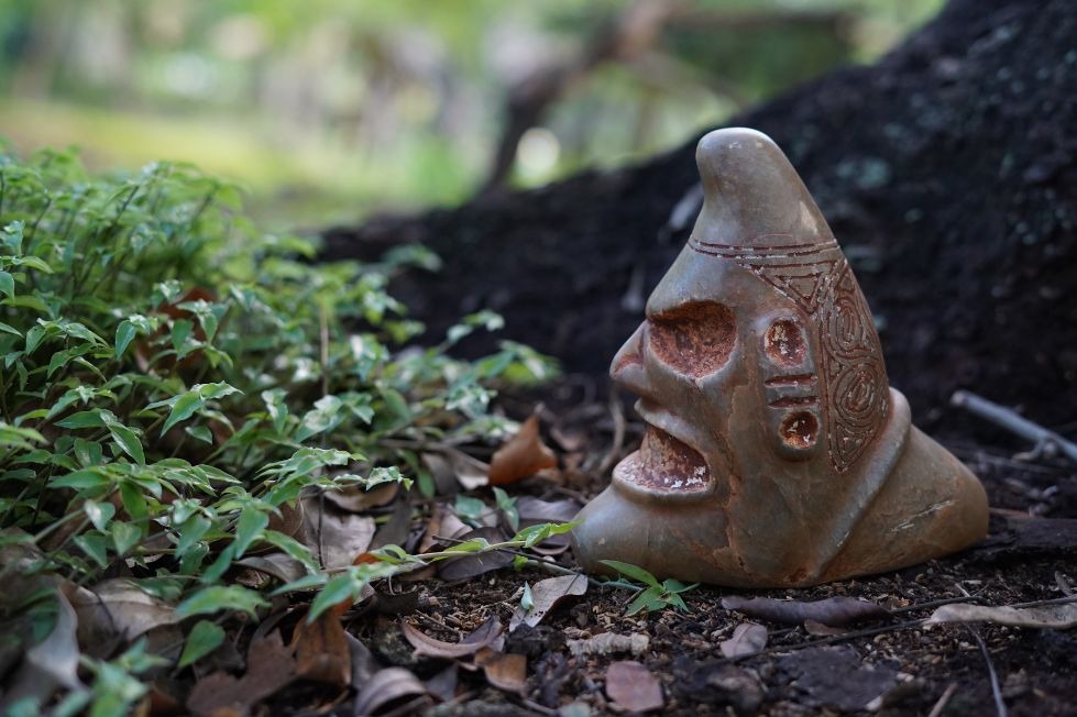 Taíno-style cemí figure outdoors, shown as cultural context for the Jayuya festival.