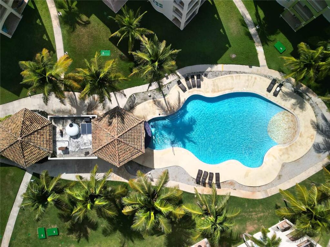 Swimming pool and landscaped grounds at Haudimar Beach Apartments in Isabela