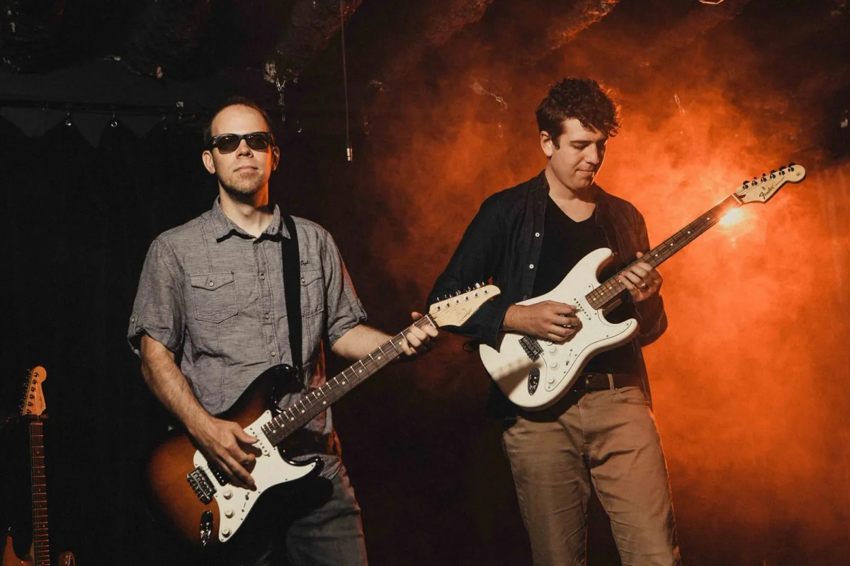 Two teachers playing bass guitar