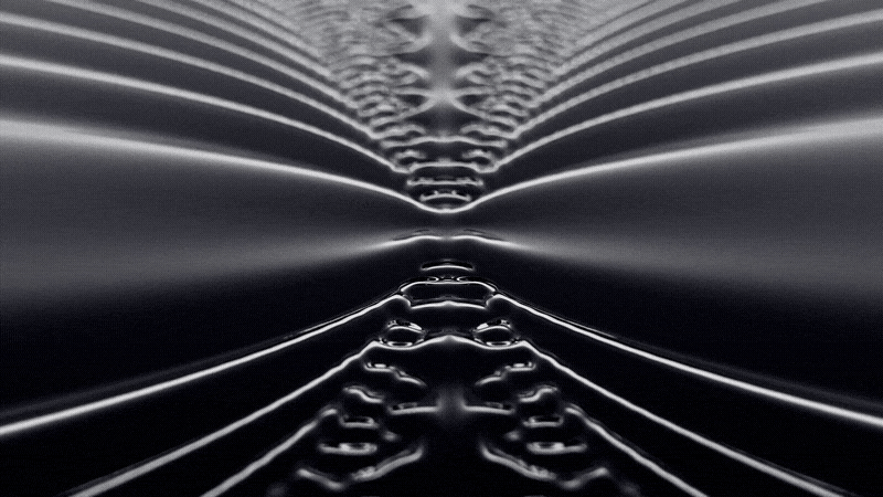 Animated ripple effect in black and white, showing fluid waves moving symmetrically upward.