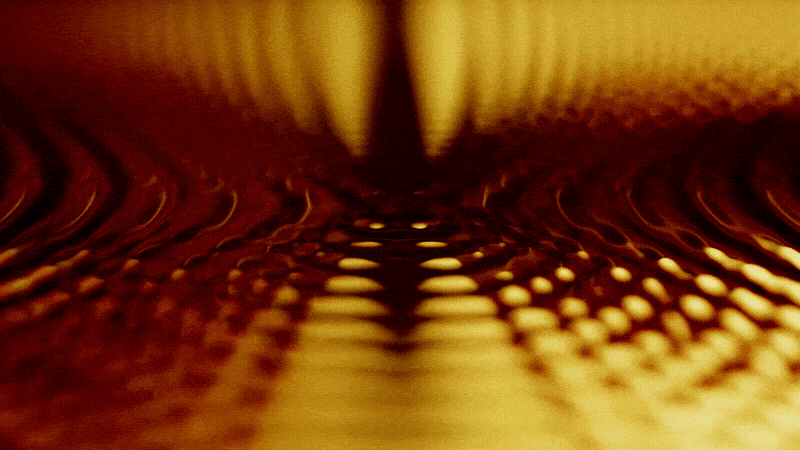 Yellow and brown hypnotic pattern with ripples forming a symmetrical wave-like effect.
