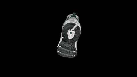 Gray and white athletic shoe sole rotating on black background.