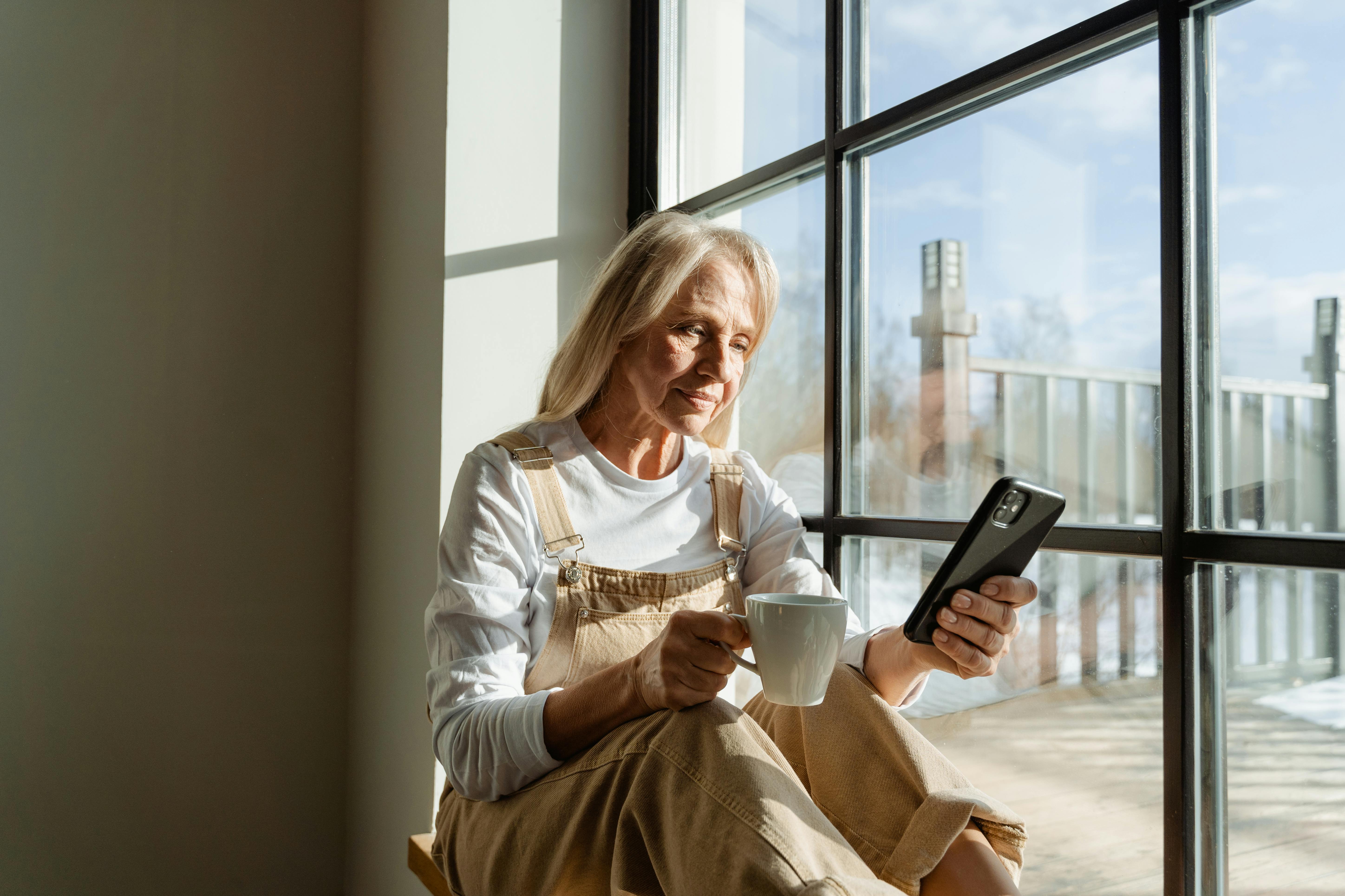 Lady sitting in the front of an apartment window