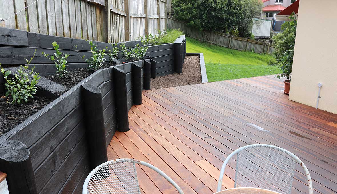 Terraced Australian backyard with retaining walls, steps, and planting designed for a sloping block