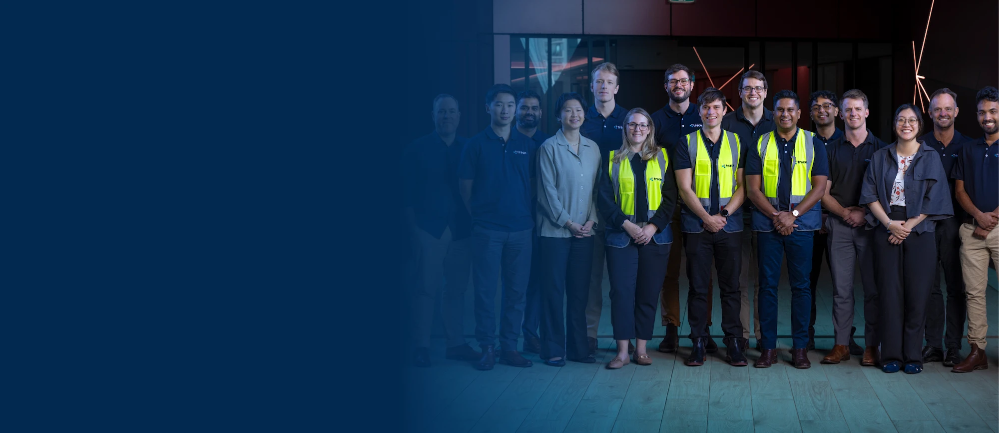 A group of people dressed in corporate attire and high vis vests