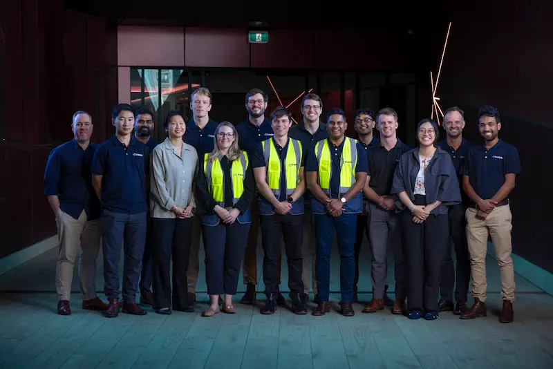 A group of people dressed in corporate attire and high vis vests