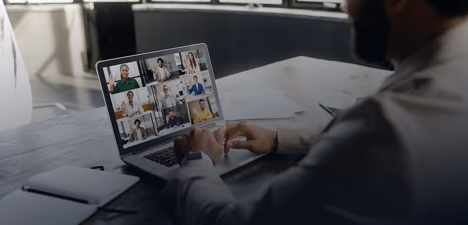 Man in video conference on laptop with multiple participants