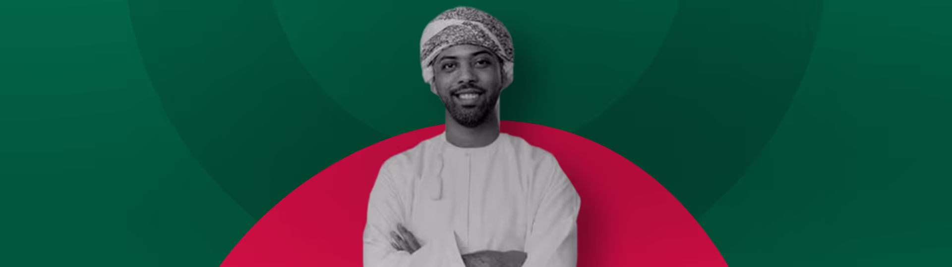 A man with a turban standing in front of a green and red background.