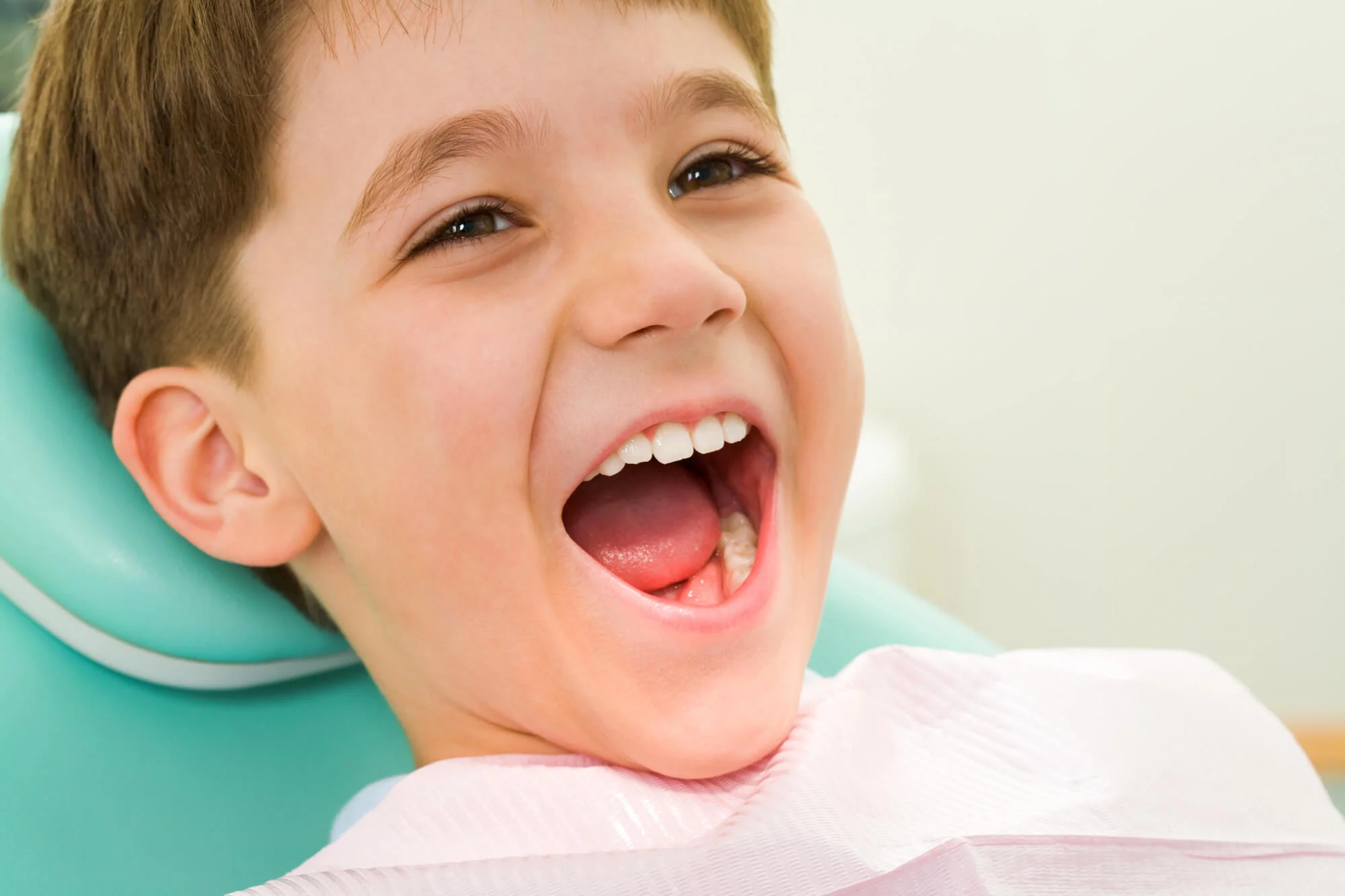 Smiling boy sitting in dental chair pediatric dentist in Murfreesboro, TN