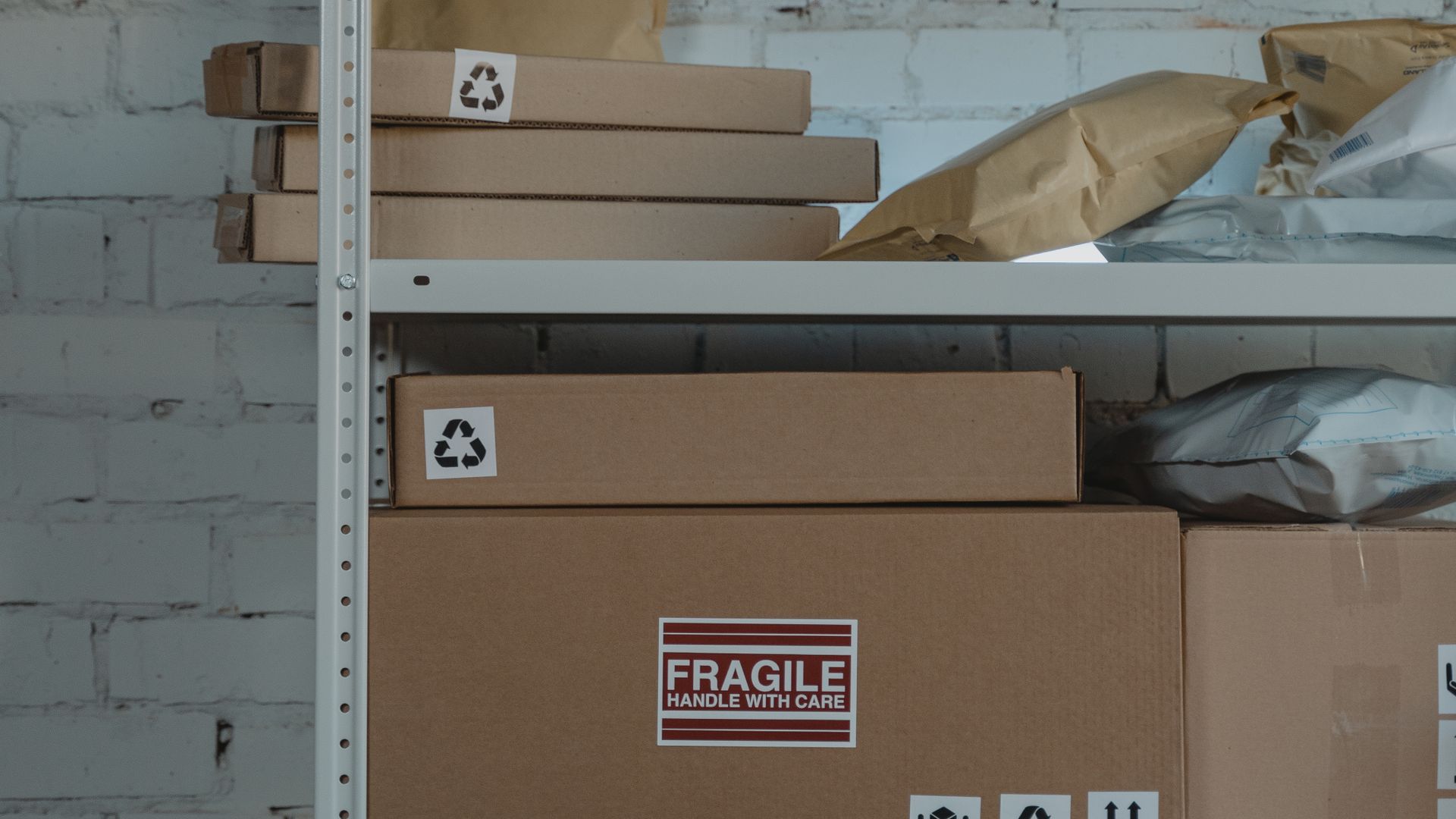 Organized, labeled cardboard boxes of stored inventory on warehouse shelving