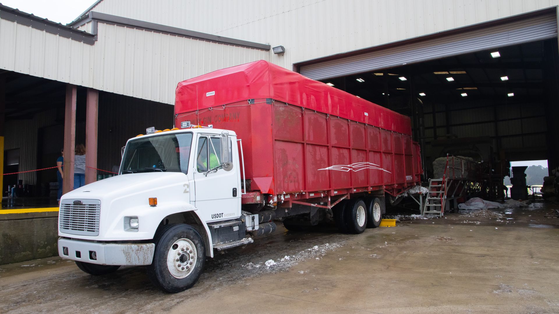 Delivery truck backed into a warehouse loading dock for cross-docking