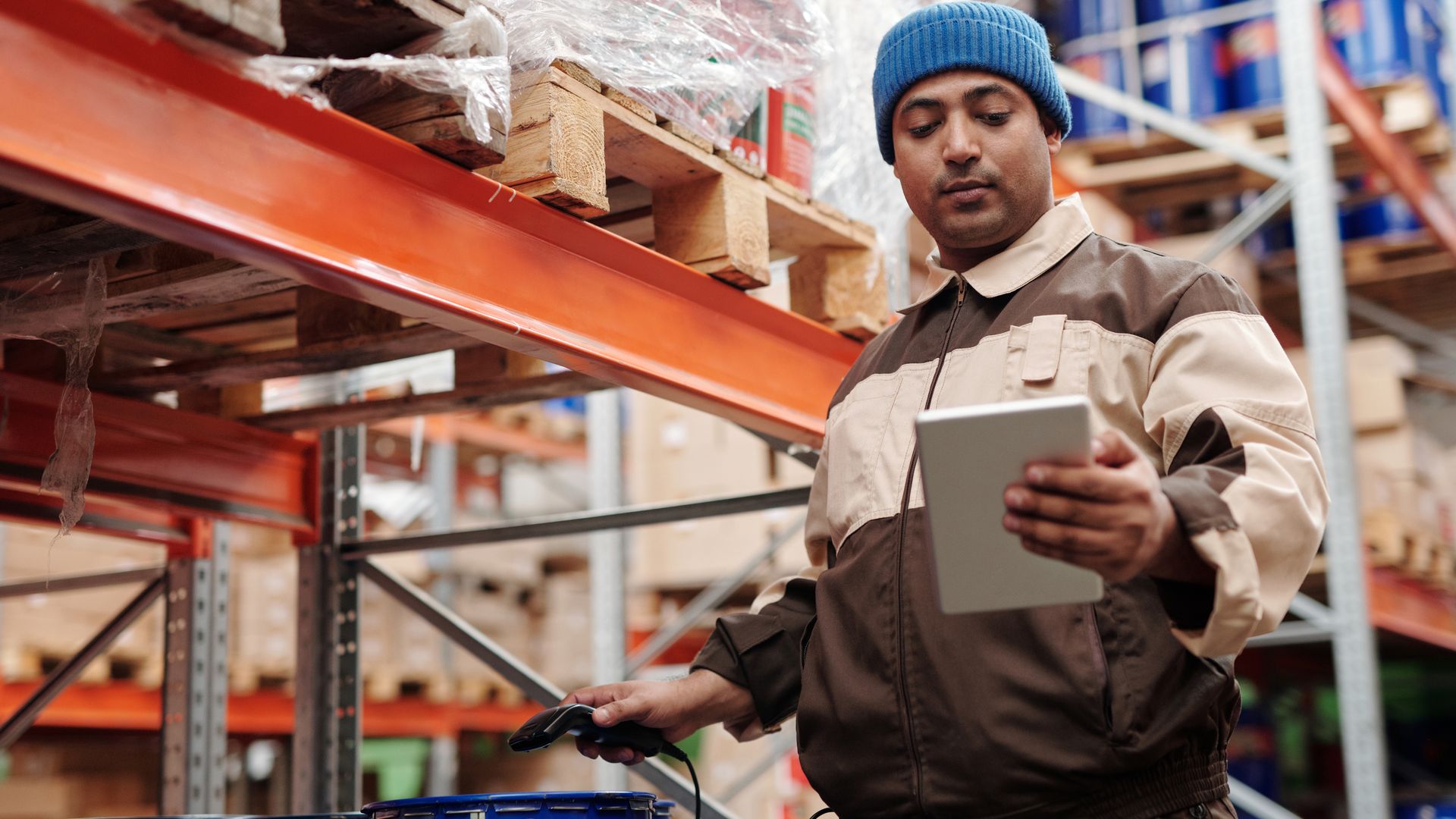 Warehouse worker checking orders on a tablet device