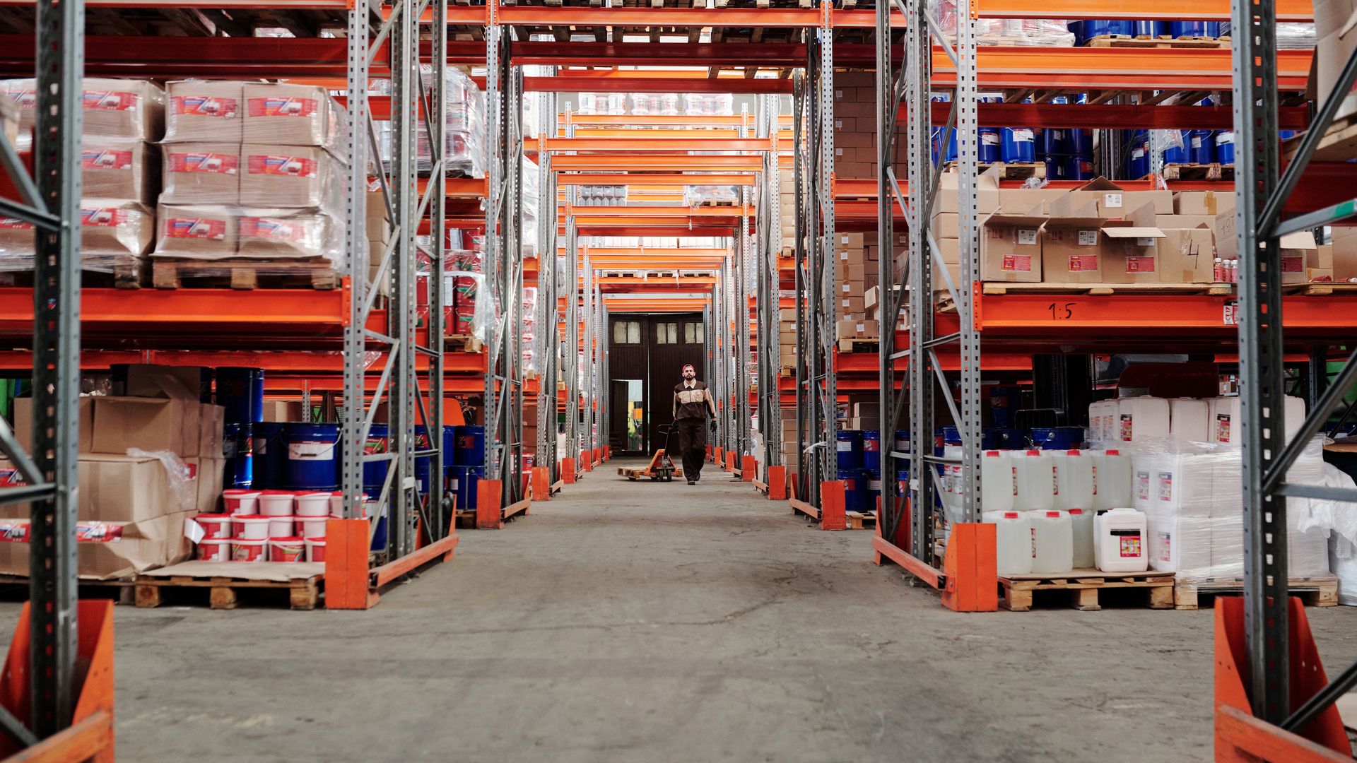 Spacious industrial ecommerce fulfillment warehouse with stocked shelves and organized inventory