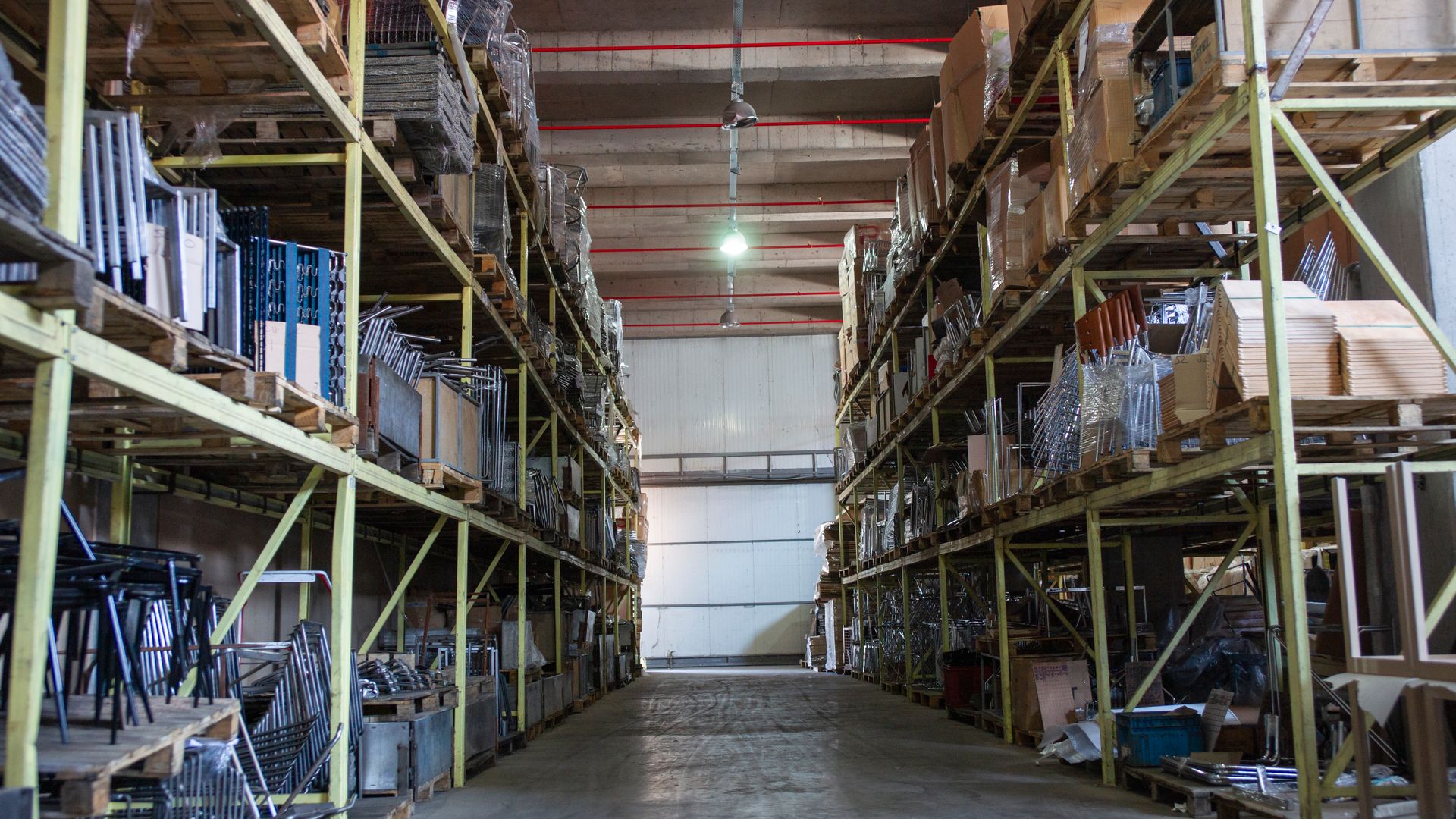 Wide aisle in a large warehouse lined with industrial pallet racking