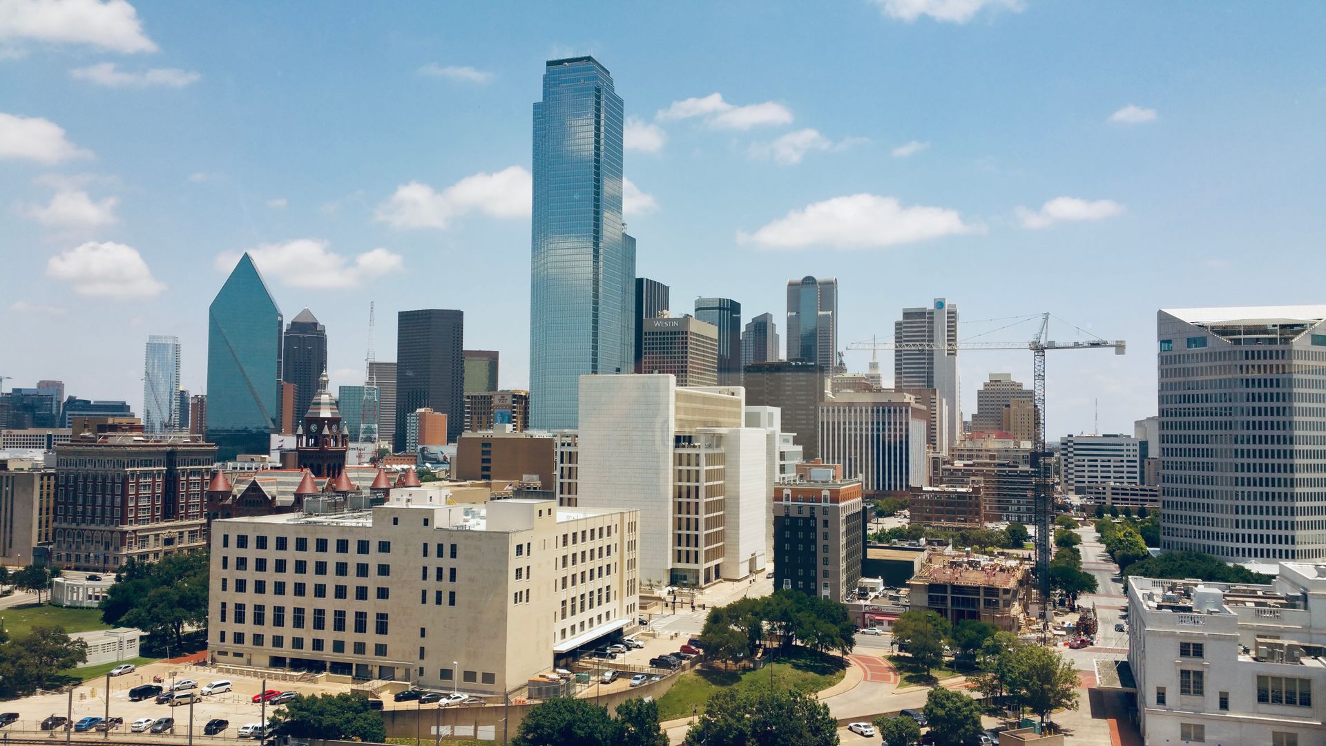 Aerial view of the Dallas, Texas skyline under a clear blue sky