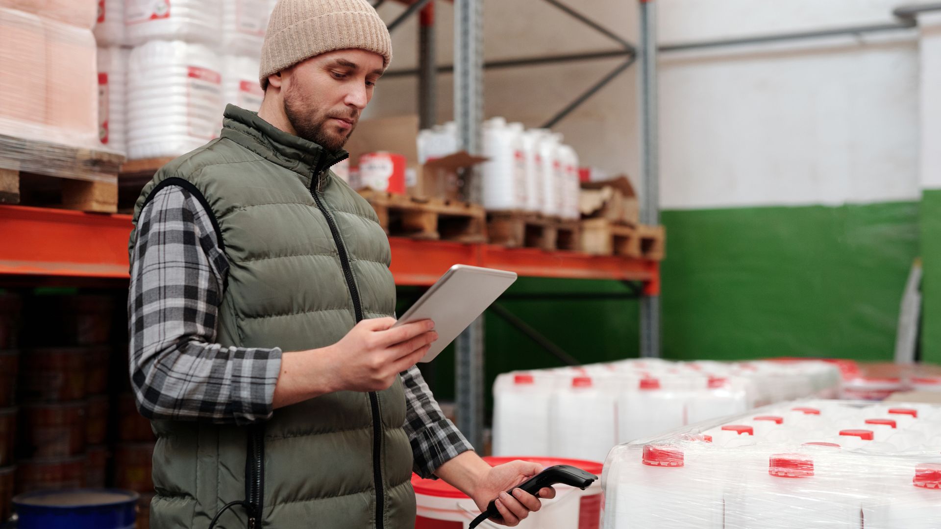 Warehouse worker counting inventory with a tablet during a cycle count