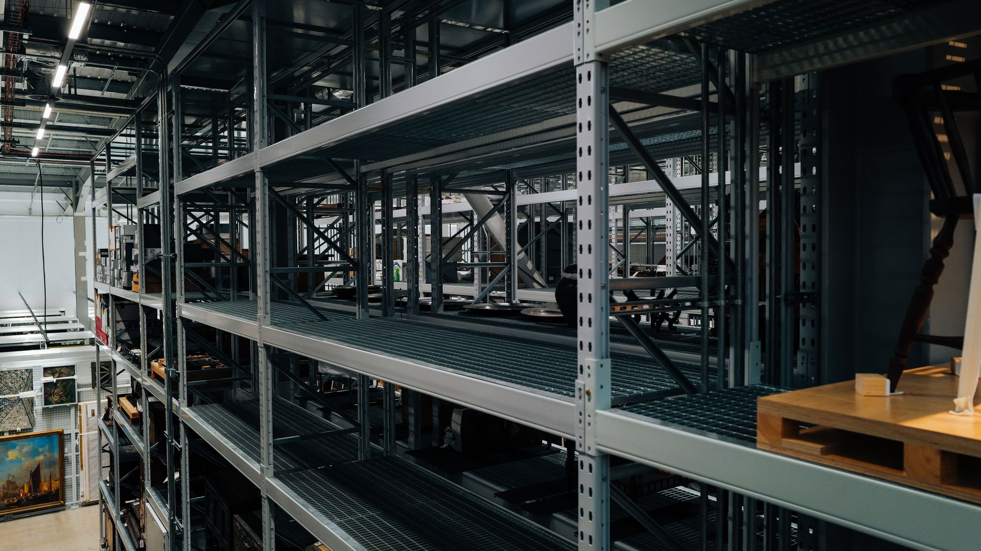 Industrial warehouse aisle with pallet racking and shelving holding stored inventory