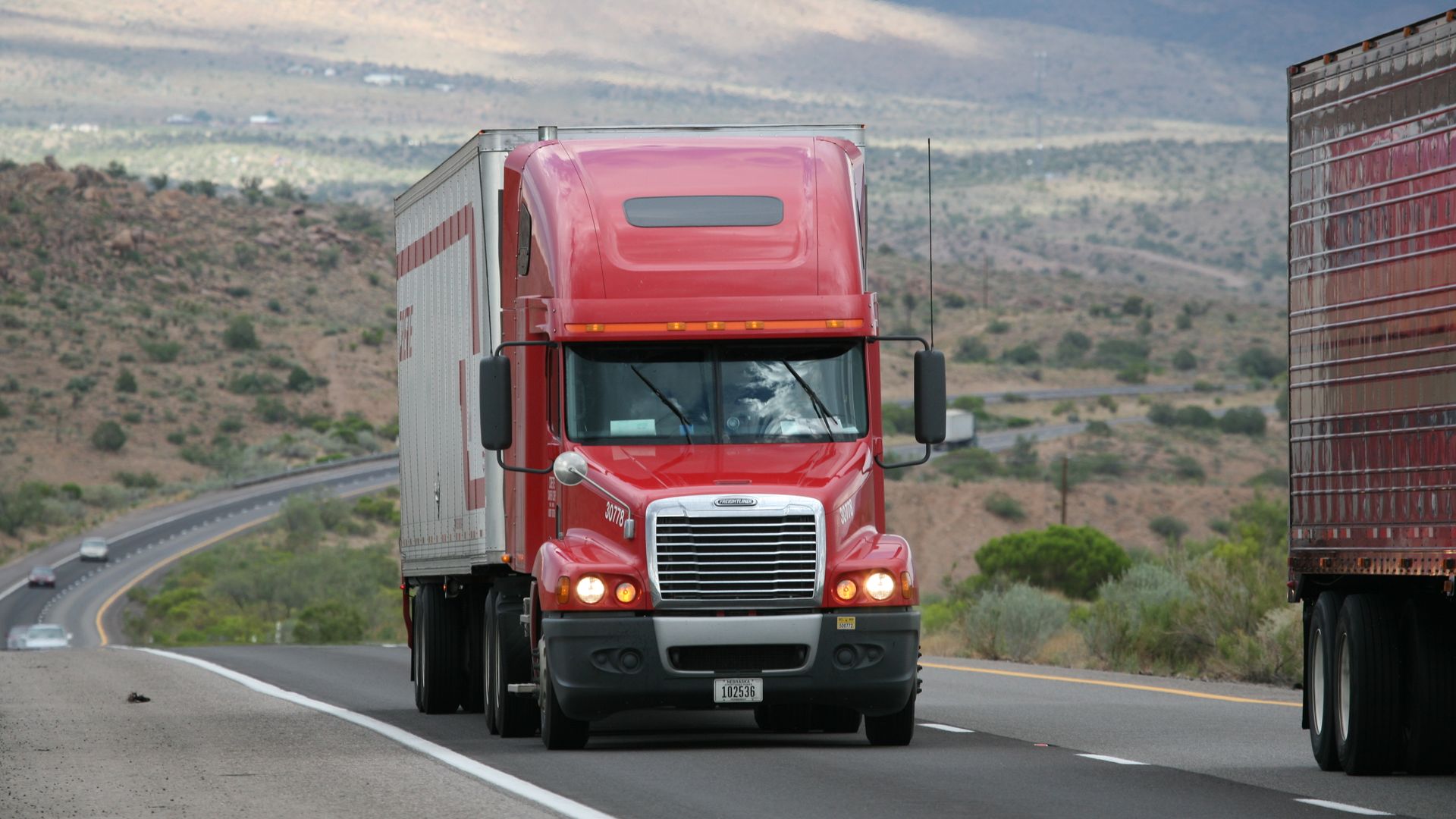 Freight truck traveling a highway, representing Midwest ground shipping coverage