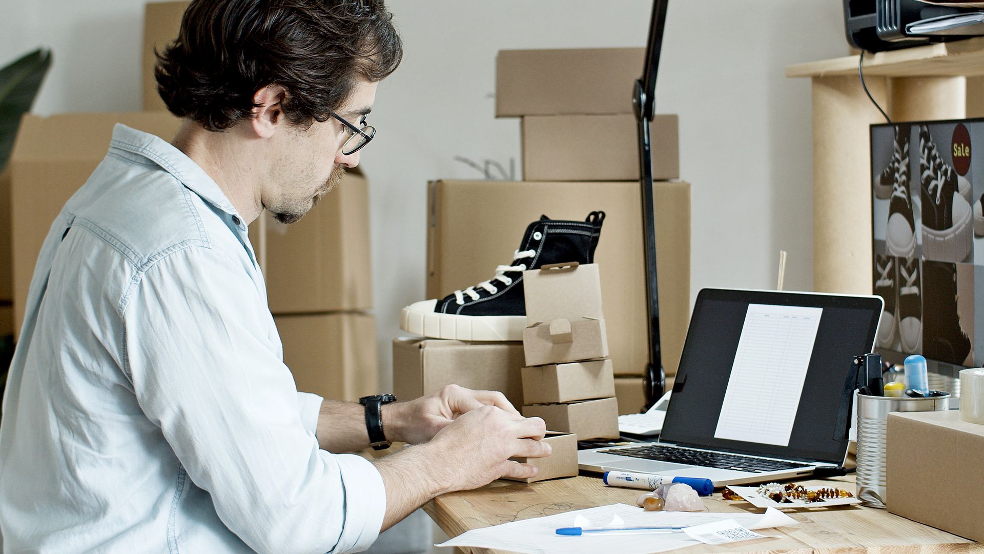 Warehouse worker preparing ecommerce packages for shipment