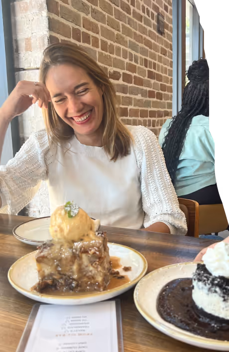 a woman sitting in a restaurant, laughing