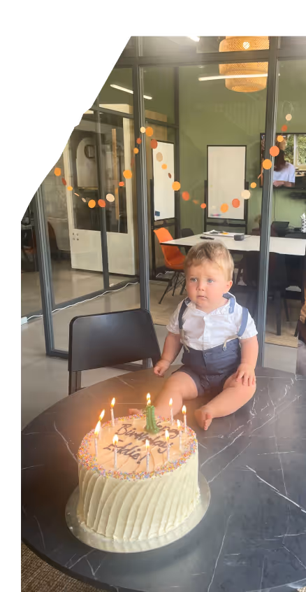 a child sitting infront of a huge cake