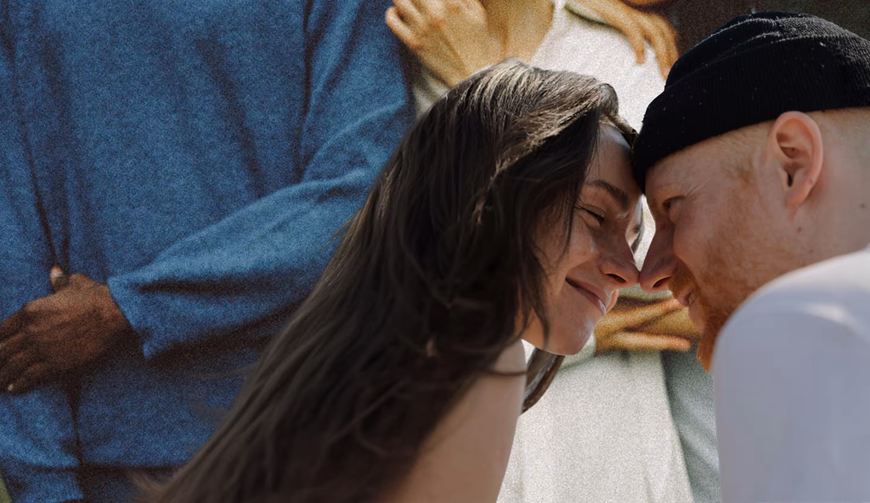 Smiling couple with foreheads touching, eyes closed, showing affection.