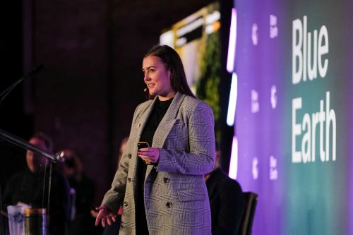 CEO Natasha Boulding on stage pitching at BE100