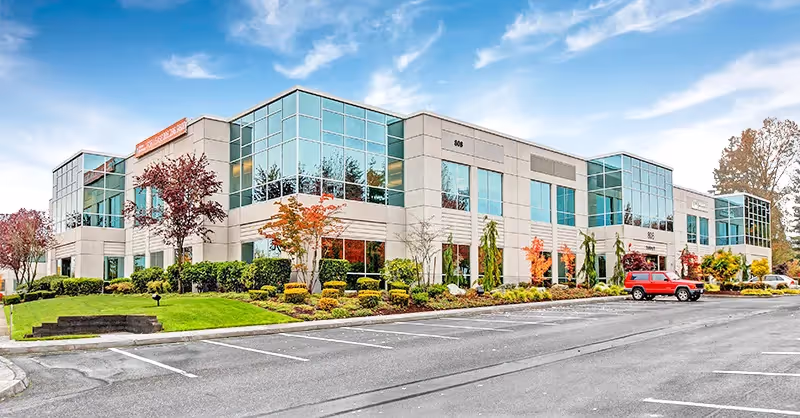 The SRM (Seattle Reproductive Medicine) fertility clinic in Everett, a modern two-story office building with large glass windows.