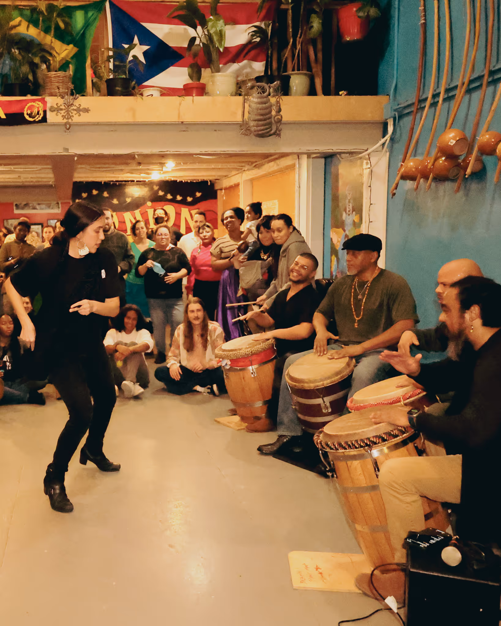 Women dancing and group playing Puerto Rican Bomba music