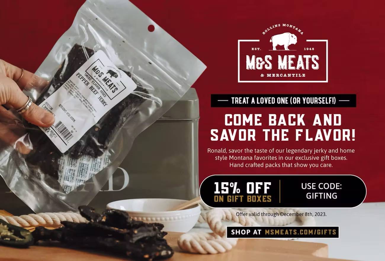 A promotional postcard from M&S Meats & Mercantile featuring a clear vacuum-sealed package of pepper beef jerky being held over a cutting board with sliced jerky, jalapeño slices, and a white dipping dish. On the right, the M&S Meats logo is displayed above the text: “Treat a loved one (or yourself)! Come back and savor the flavor! Ronald, savor the taste of our legendary jerky and home style Montana favorites in our exclusive gift boxes. Hand crafted packs that show you care.” A bold black-and-gold callout offers “15% OFF on gift boxes” with promo code “GIFTING.” Text below notes the offer is valid through December 8th, 2023, with a button reading “Shop at msmeats.com/gifts.”  